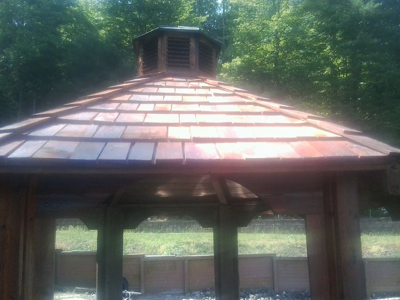 New cedar shake roof and cupola on a lakeside gazebo in Thornton